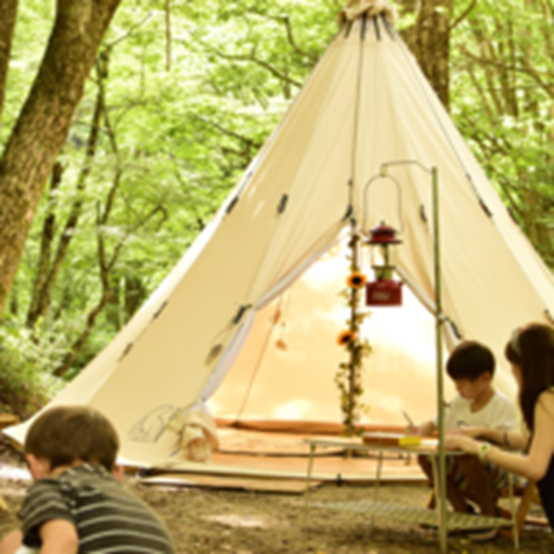 Children camping in a Japanese forest with a Nordisk glamping tent and red lantern.