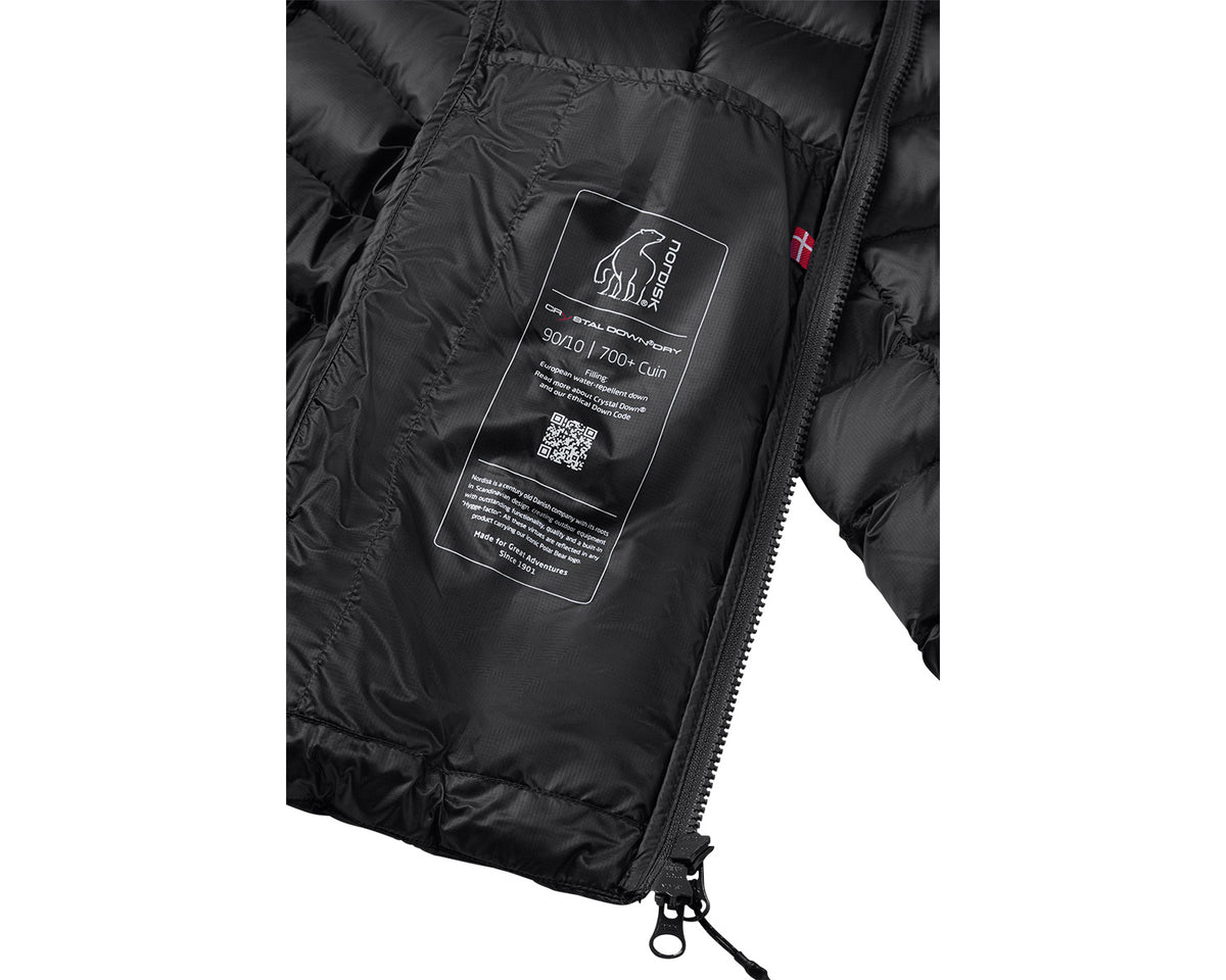 Close-up of a black puffer jacket with a brand label on a white background