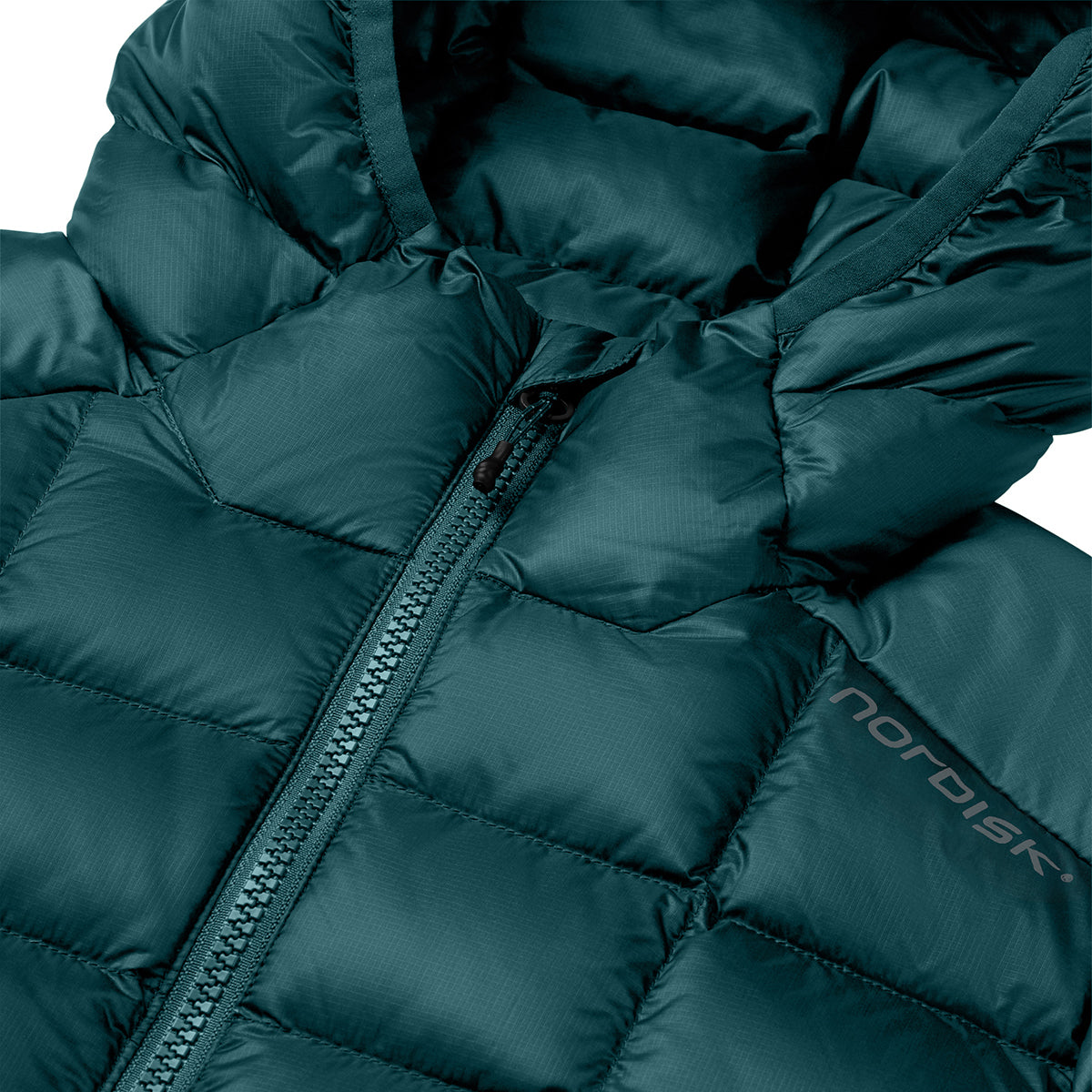 Close-up of a dark teal hooded puffer jacket with a front zipper and a visible Nordisk logo on the lower right side.