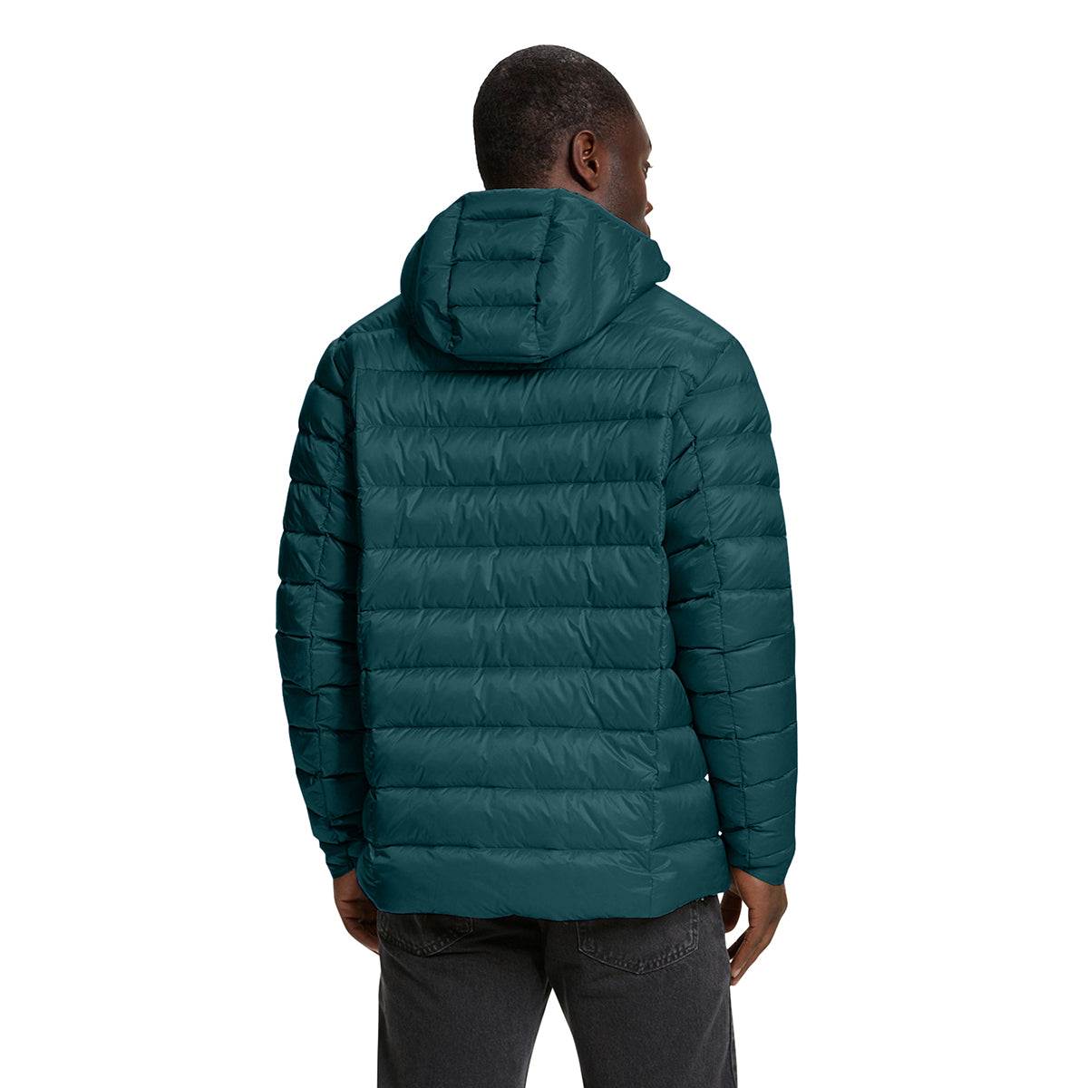 A man viewed from the back wearing a dark teal hooded puffer jacket and dark gray jeans, set against a plain white background.