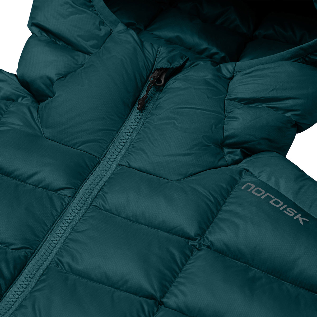 Close-up of a dark teal puffer jacket with a front zipper, quilted baffles, and a visible Nordisk logo on the chest.