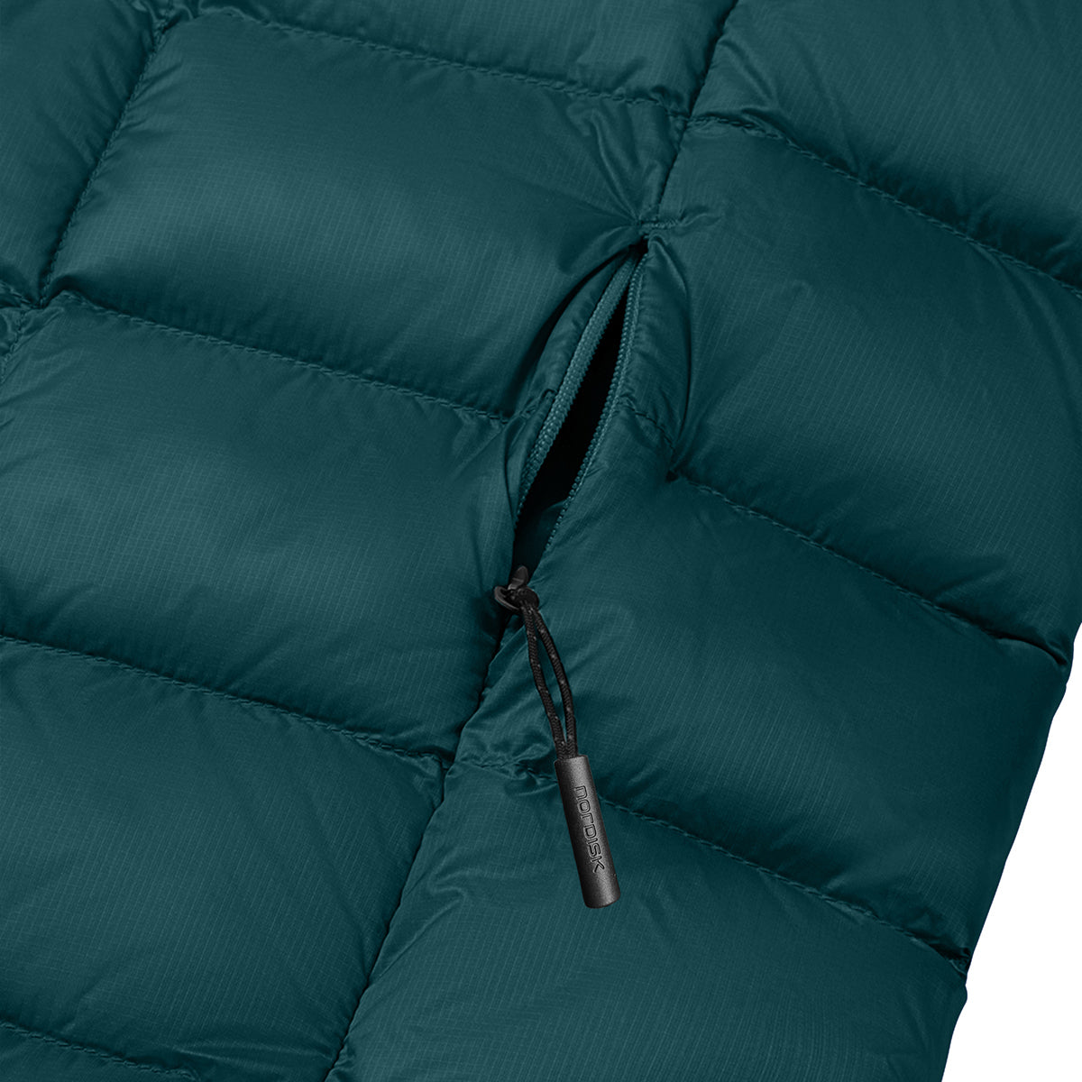Close-up of a dark teal puffer jacket showing the quilted texture and a black zipper with a branded pull tab.