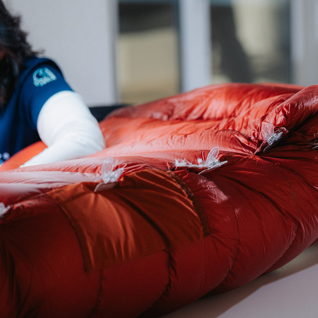 Seamstress working on a red down sleeping bag at Die Manufaktur in Görlitz