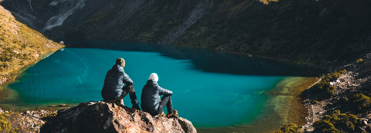Maximilian and Sebastian Lehrke overlooking a turquoise mountain lake during a hiking trip specifically in Peru.
