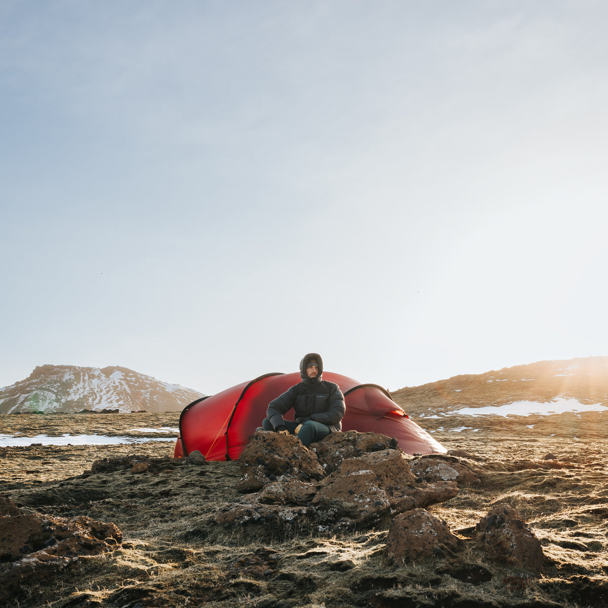 Wild camping in Norway with a red Nordisk Seiland tent during the arctic summer.