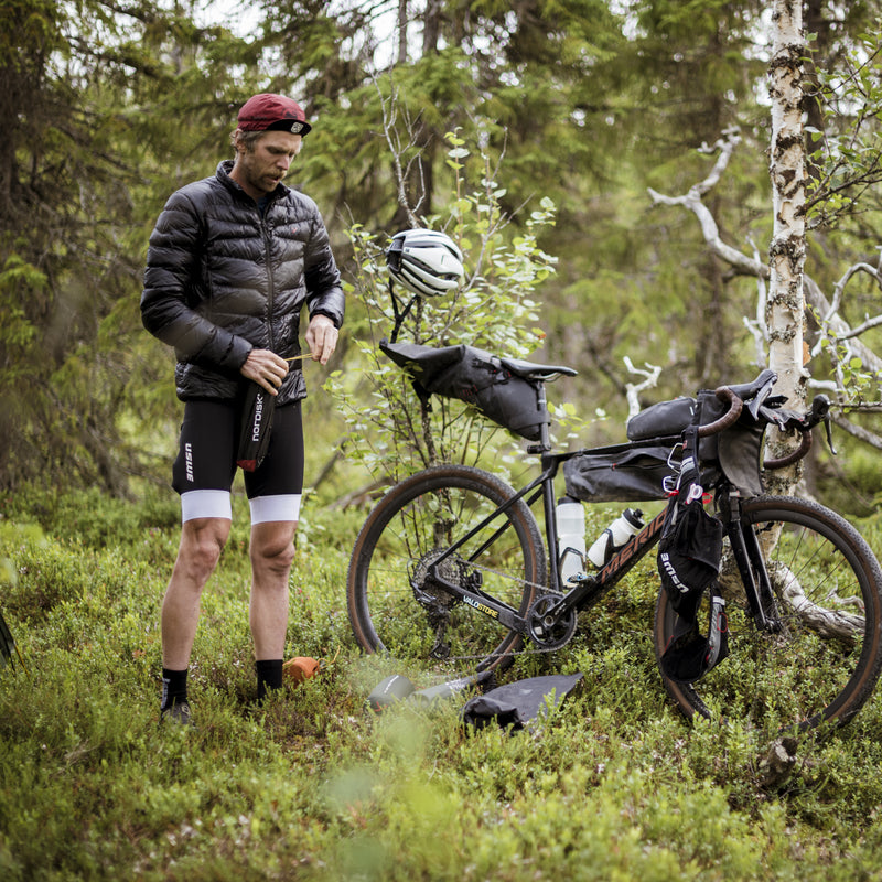 Nordisk hero André Jonsson bikepacking in the woods with his gravel bike and outdoor gear.