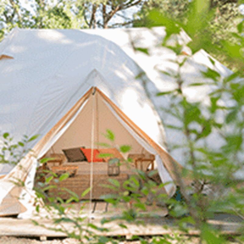 A large white Nordisk Vanaheim glamping tent set up at the Nordisk Village in Italy.