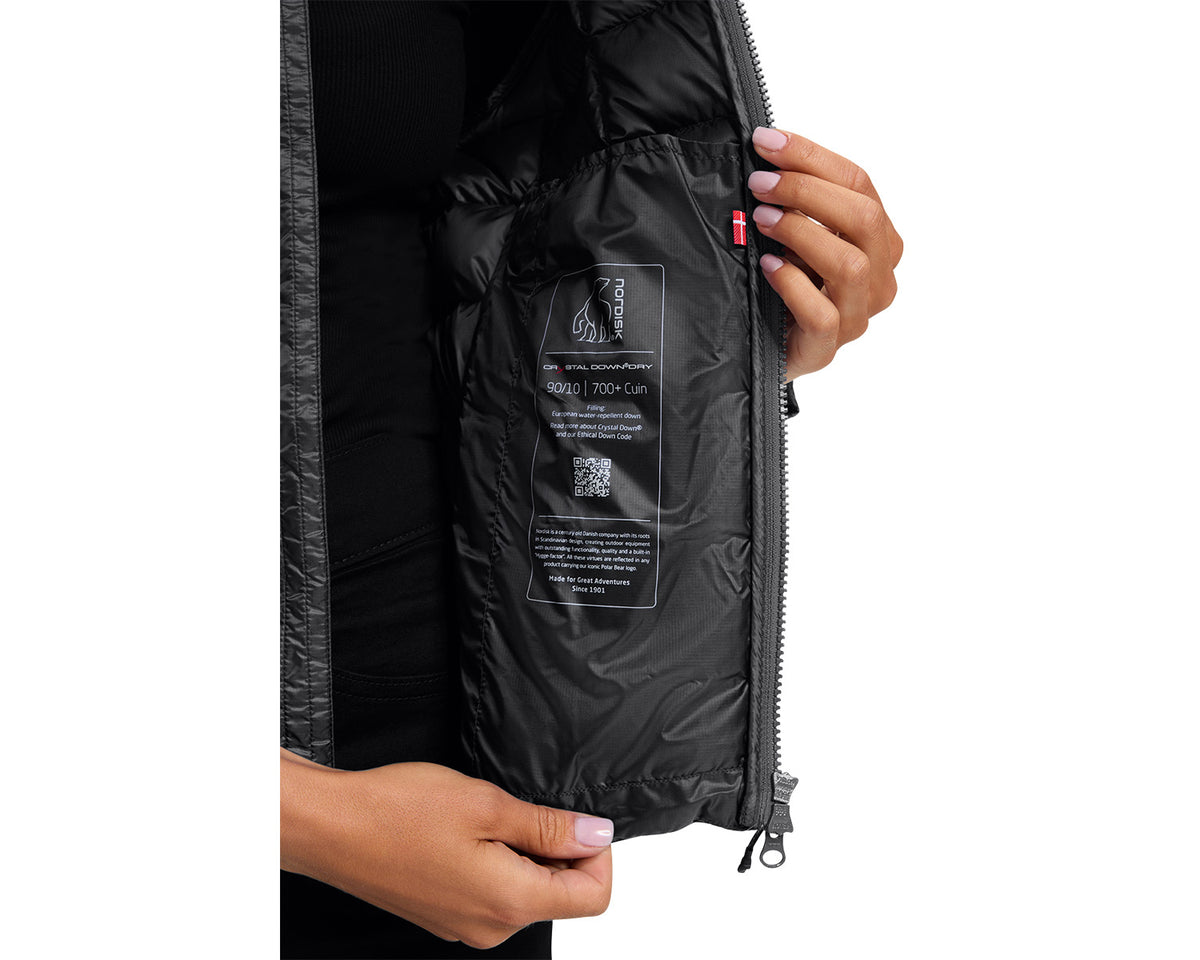 Close-up of a person opening a black jacket with a visible brand label.