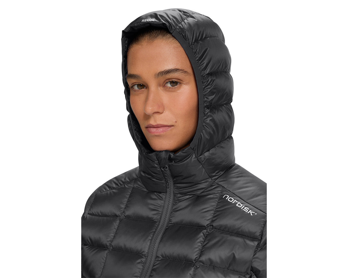 Person wearing a black hooded jacket with Nordisk logo on a white background