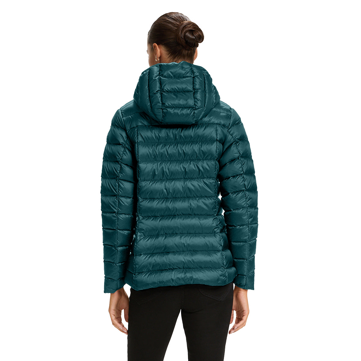 A woman viewed from the back wearing a dark teal hooded puffer jacket and black pants against a plain white studio background.