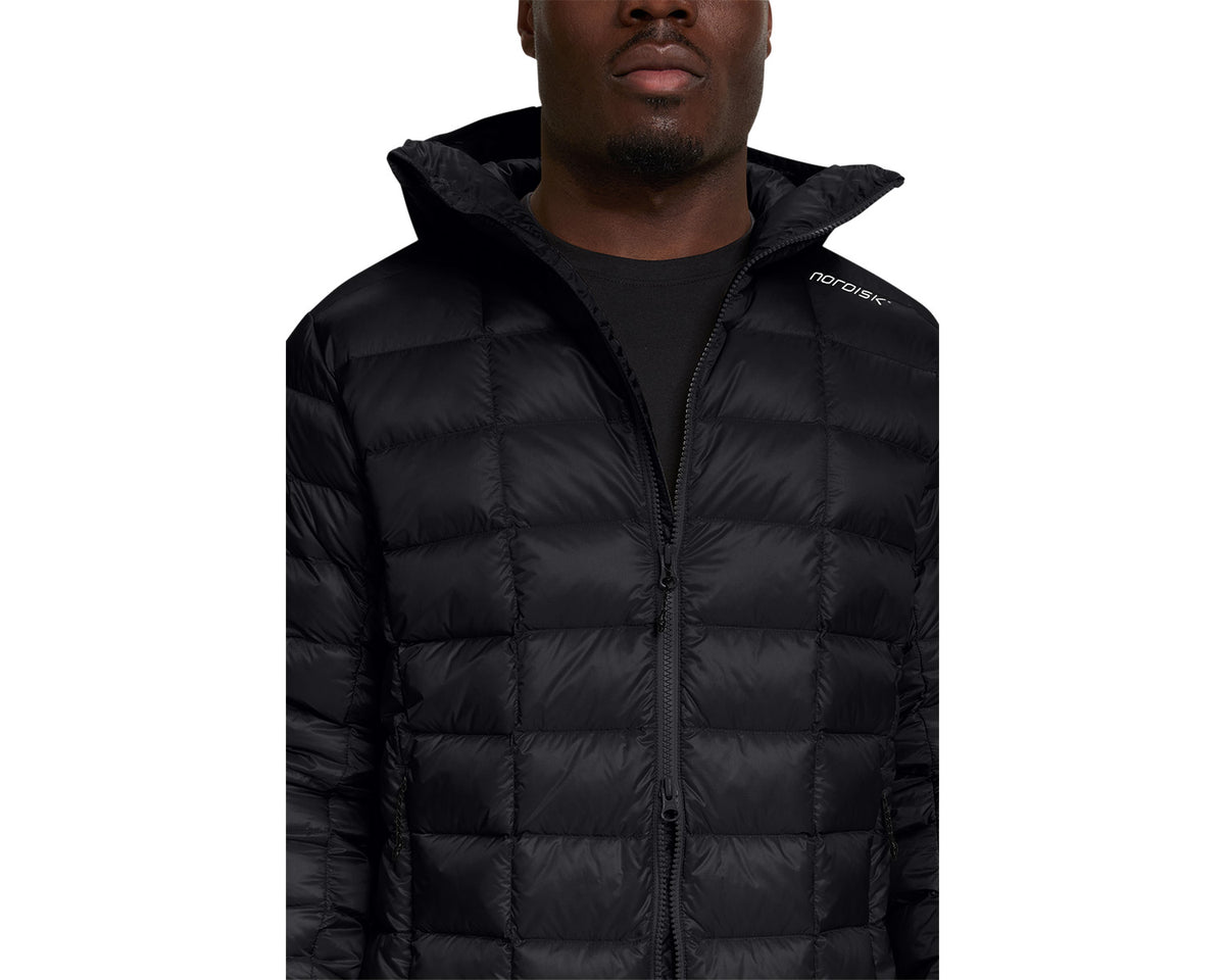 Person wearing a black puffer jacket with a brand logo on a white background