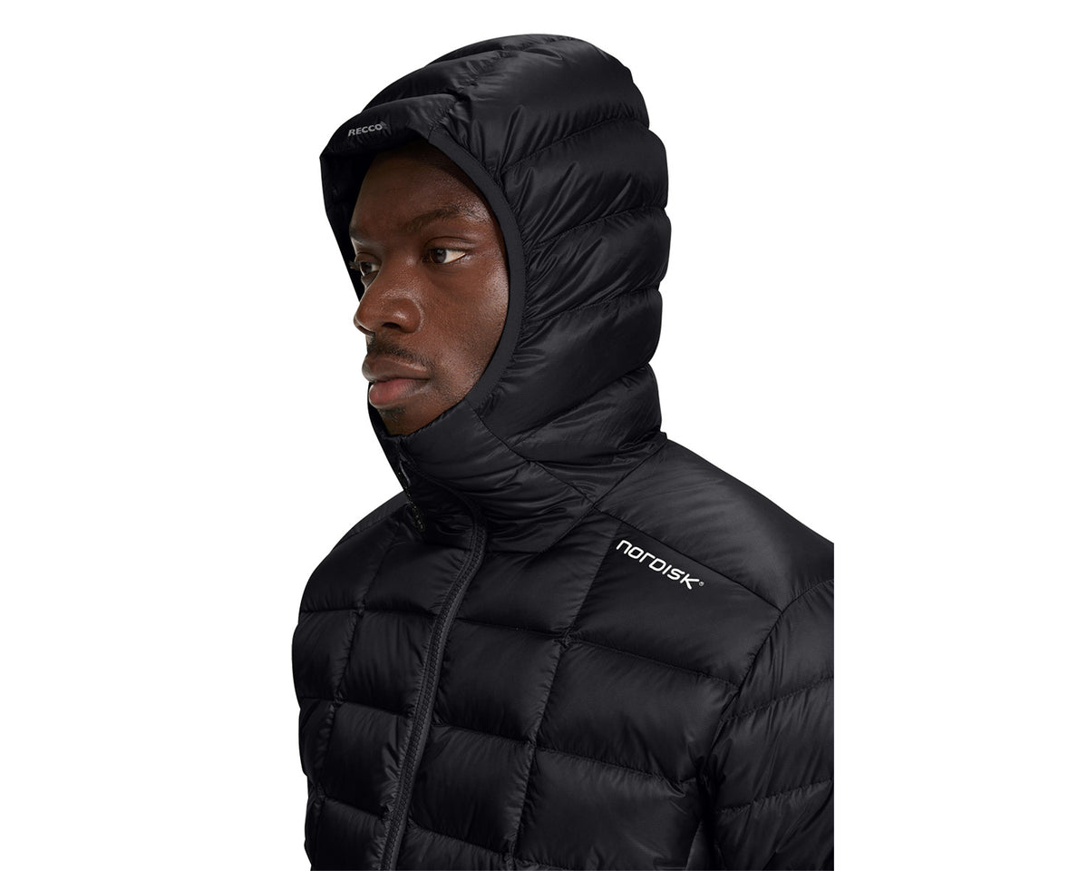 Person wearing a black puffer jacket with a hood on a white background