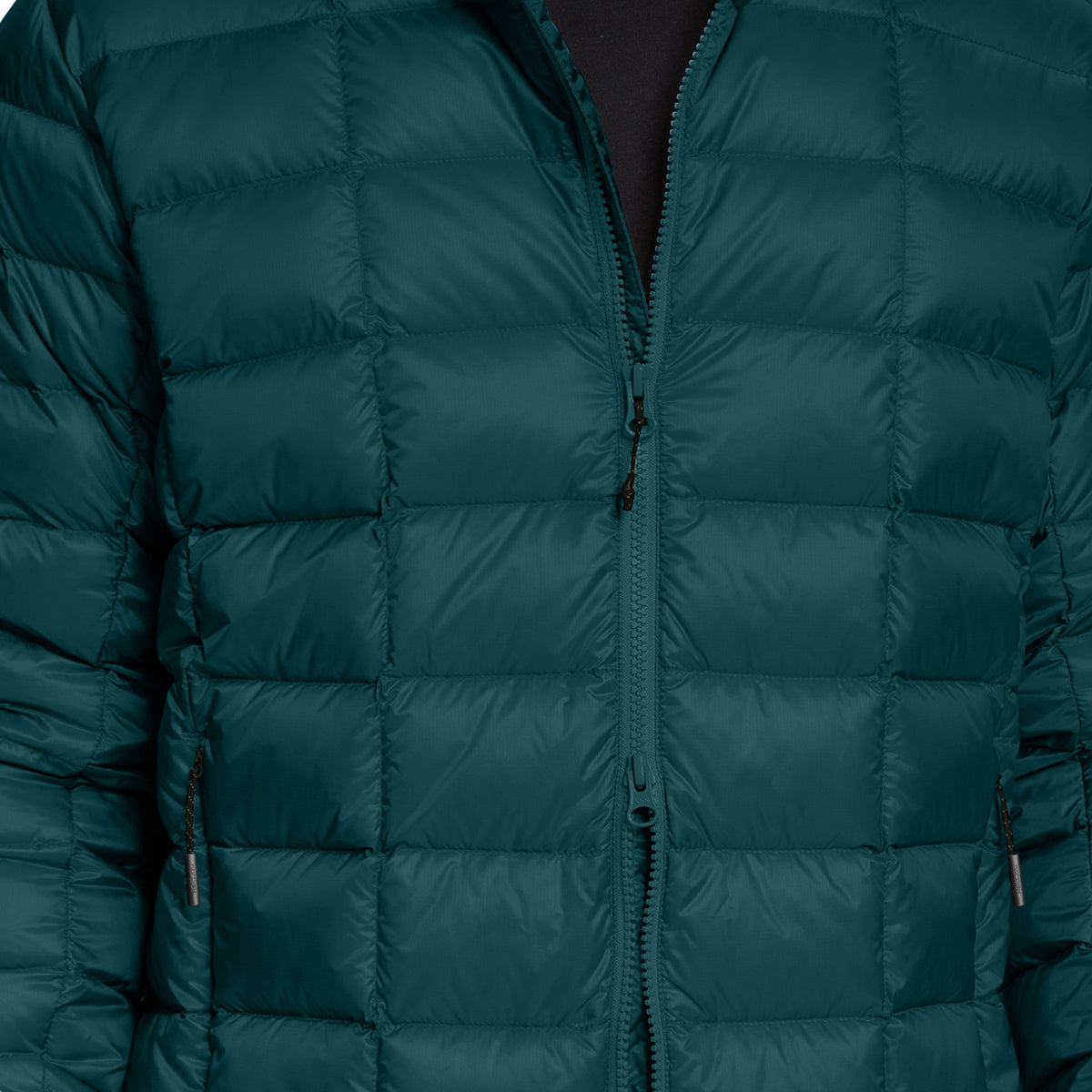 Close-up of a dark teal green quilted puffer jacket with a front zipper and horizontal baffles.