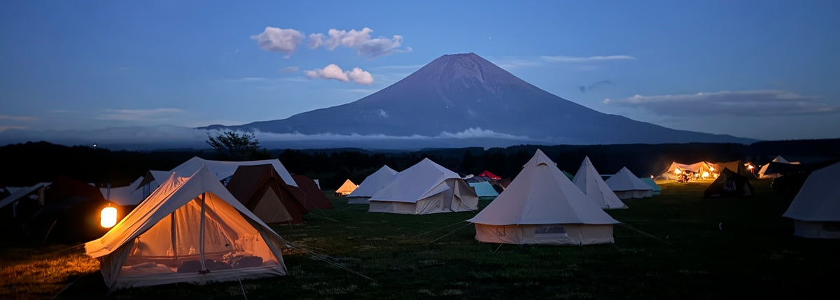 Glamping with Nordisk cotton tents at a hygge event with a mountain view.