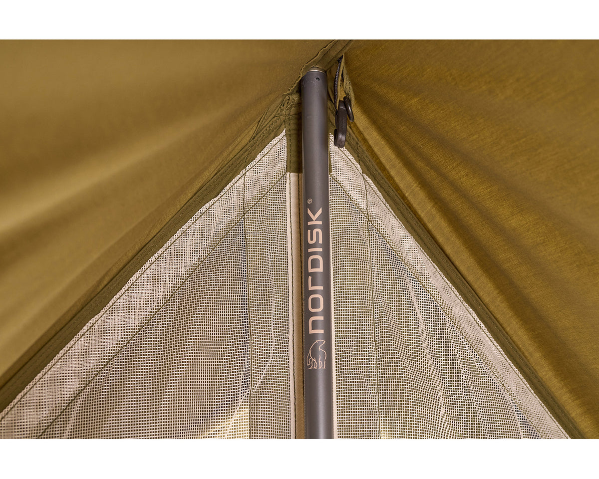 Close-up of a camping tent with Nordisk branding on a brown background