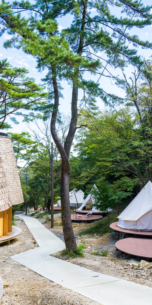 Nordisk glamping tents on wooden platforms at Hygge Circles Ugakei sustainable camping center in Japan.