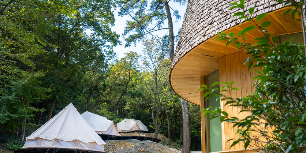 Glamping tents and sustainable wooden cabins at Nordisk Hygge Circles Ugakei in Japan.